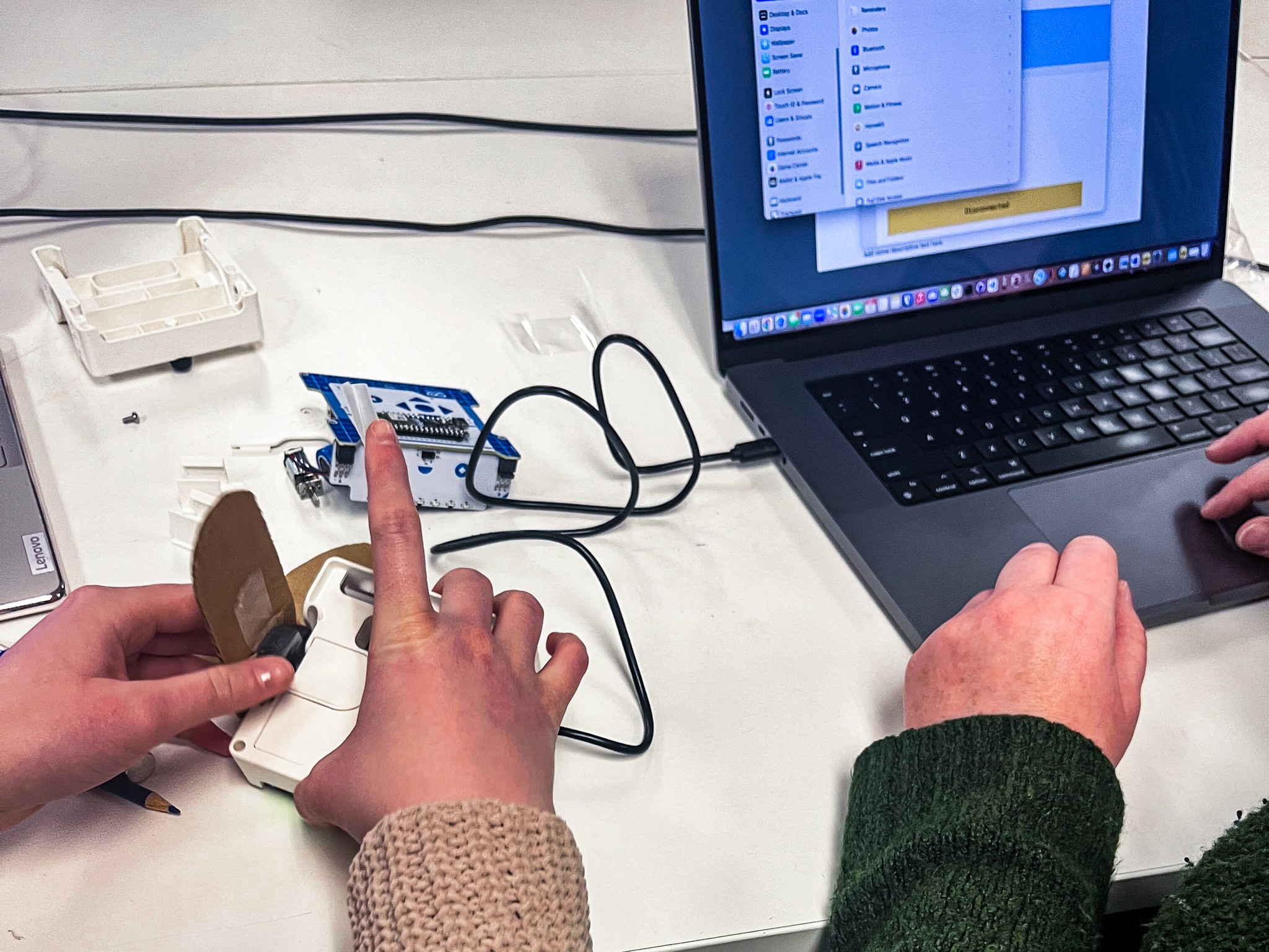 Close-up of a TUFTS University student using the Arduino Alvik robot car during usability testing session – Liam Aljundi