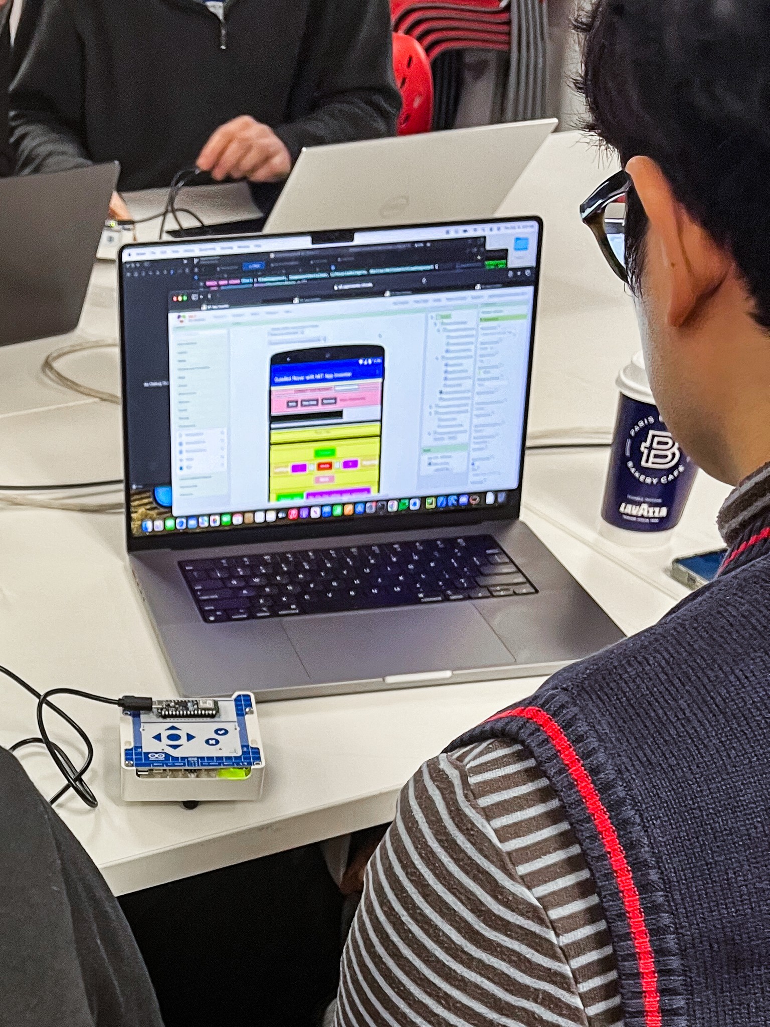 Close-up of a TUFTS University student using the Arduino Alvik robot car by hooking it up to a custom app during usability testing session – Liam Aljundi